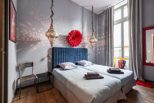 a bedroom with a large bed with a red ball on the wall at The Cosmopolitan Lodge in Cannes