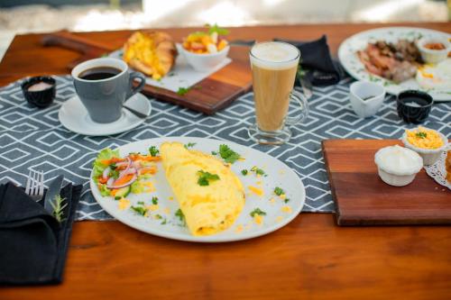 Una mesa cubierta con platos de comida y bebidas. en Aan de Eike Guest House, en Swellendam