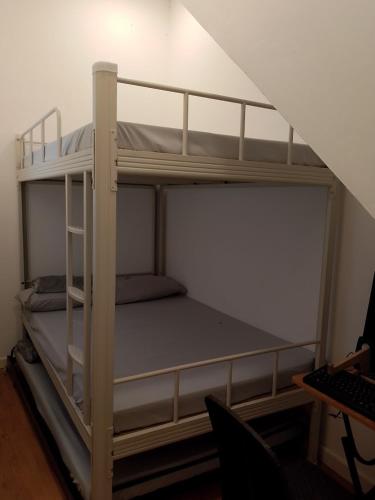 two bunk beds in a room with a desk at Malvar Lodge in San Isidro Sur