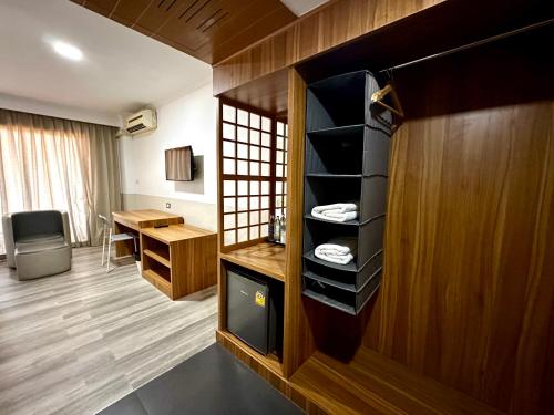 a room with a desk and a room with a room at Garden Paradise in Pattaya North