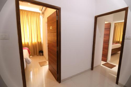 a mirror in a room with a bedroom at J Park Auroville Beach in Kottakupam