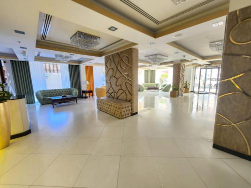 a lobby of a hotel with a waiting area at Garden Hotel Muscat By Royal Titan Group in Muscat