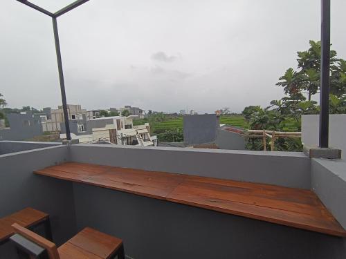 a balcony with a table and a view of a city at Villa Royal Arois Syariah Dekat Jatim Park 3 in Tlekung