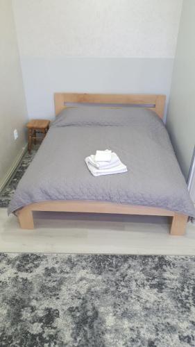 a bedroom with a bed with a gray bedspread at Apartment in Truskavets in Truskavets