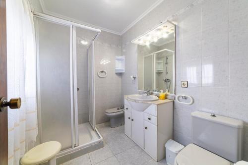 a bathroom with a shower and a toilet and a sink at Mi Locura Costa Cabana in Almería