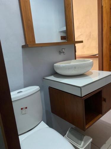 a bathroom with a sink and a toilet at Pranajayaloka private villa in Tejakula