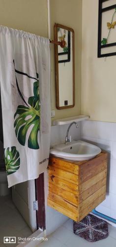 a bathroom with a sink and a shower curtain at V House in Phra Nakhon Si Ayutthaya