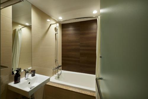 a bathroom with a sink and a bath tub at ALFIT HOTEL & BAR AKASAKA in Tokyo