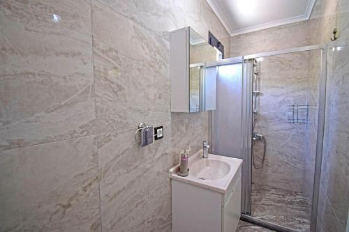 a bathroom with a sink and a shower at Villa Kozalak 1 in Fethiye