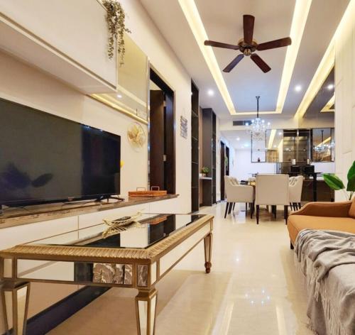 a living room with a large television and a couch at Dorsett Residences Bukit Bintang in Kuala Lumpur