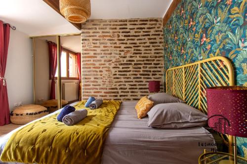 a bedroom with a large bed with pillows on it at The Nest, parking, centre, vue sur la Cathédrale in Albi