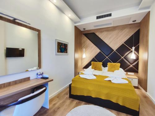 a bedroom with a yellow bed with a large mirror at Spa Residence Carbona Water Lily Apartment in Hévíz