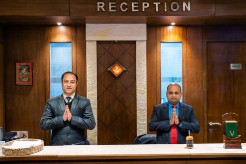 two men in ties are sitting at a table at Hotel Viceroy in Darjeeling
