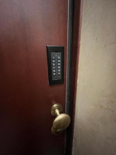a door with a remote control on it at Calari Rooms - Affittacamere in Bologna