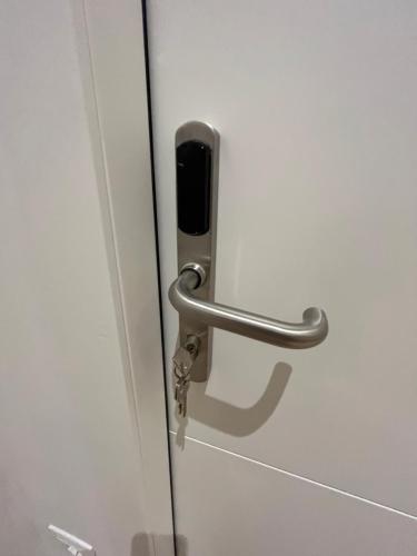 a door with a handle on a white door at Calari Rooms - Affittacamere in Bologna
