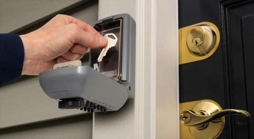 a person is unlocking a door with a key at Le Carlier d'Enghien - 2 chambres - Près du Lac in Enghien-les-Bains