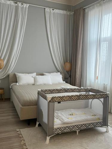 a bedroom with two beds in front of a window at La Strada Apartments in Oradea