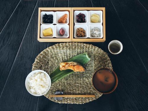 una mesa con un plato de comida y arroz en Kominakayado LOOF Iwainoie, en Higashi-hanawa