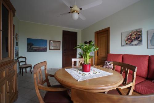 a living room with a table and a couch at La Casa di Rina in Angera