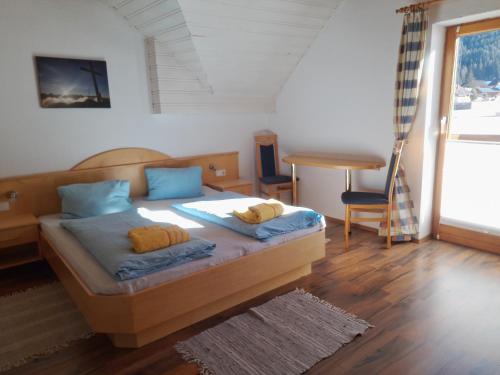 a bedroom with a bed with blue pillows on it at Gästehaus Ferner in Sankt Michael im Lungau