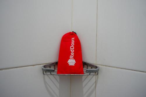 a red bag is hanging on a wall at RedDoorz at Jalan Emmy Saelan Palu in Palu