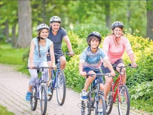 a group of people riding bikes down a path at كبائن النصر المعمورة الشاطىء 7 in Alexandria