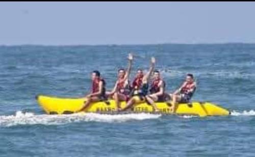 a group of people sitting on a banana boat in the water at كبائن النصر المعمورة الشاطىء 7 in Alexandria