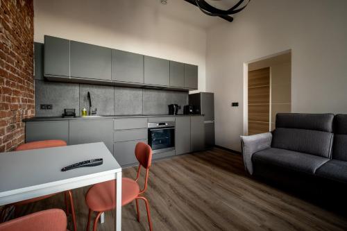a kitchen and living room with a table and chairs at RentPlanet - Apartamenty Krasińskiego in Wrocław