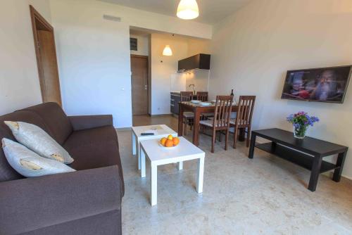 a living room with a couch and a table at Apartments Kuce Lekovica Beach & snack bar- Bistro in Bar