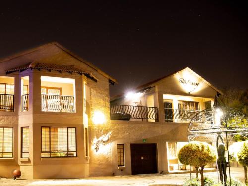 a large building at night with lights at The Orion in Middelburg