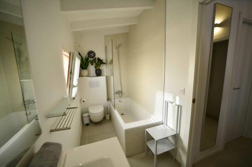 a bathroom with a tub and a toilet and a sink at CASABLANCA in Jávea