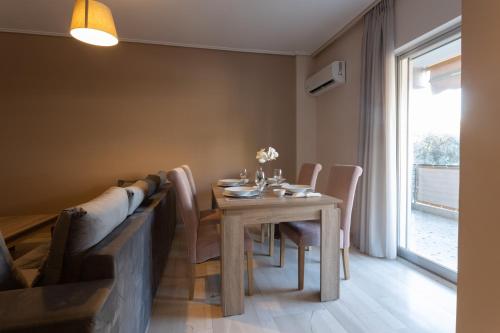 a dining room with a table and chairs and a window at Glyfada downtown in Athens