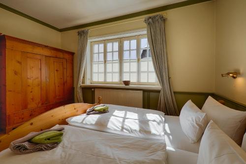 a bedroom with a large bed and a window at Ferienresort Damerow in Koserow