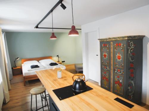 a kitchen with a tea kettle on a counter with a bed at Alte Seifensiederei - Rainer Maria in Bad Tölz