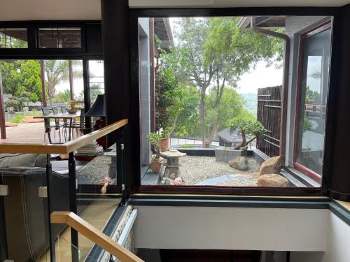 a room with a window looking out at a garden at Oasis On Lily with OWN Pool in Johannesburg
