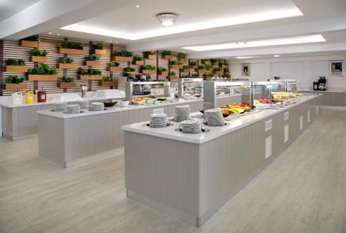 a restaurant with a buffet line with food on display at Asterias Beach Hotel in Ayia Napa