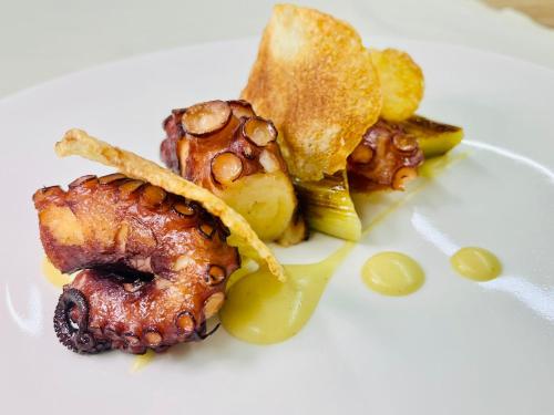 a plate of food with meat and vegetables on it at Villa Nonna Cicci Boutique Hotel - SPA in Cisterna dʼAsti