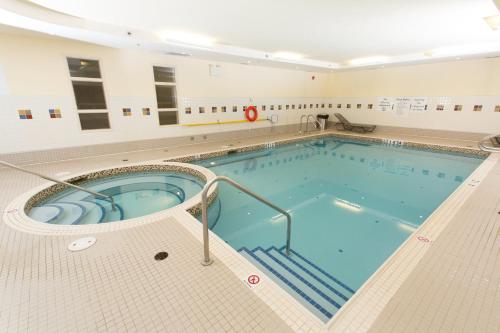 a large swimming pool in a building at Holiday Inn & Suites Lloydminster by IHG in Lloydminster