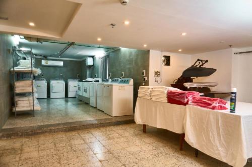 a large room with a drying room with tables and machines at Selat Al Bait Hotel in Makkah