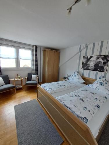 a bedroom with a bed and a living room at Wein- und Gästehaus Lentes in Trittenheim