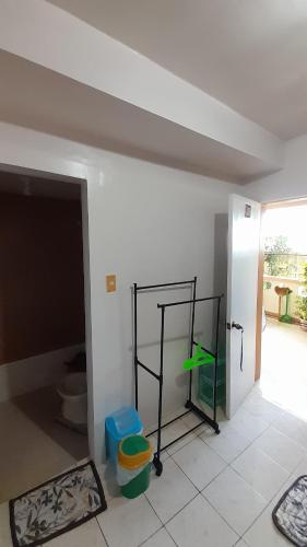 a room with a bathroom with a toilet in it at Reynaldo's Upstairs in Puerto Galera