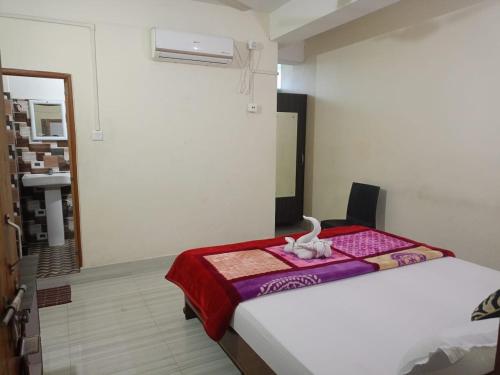a bedroom with a bed with a towel on it at Hotel Kaziranga Holidays in Kāziranga