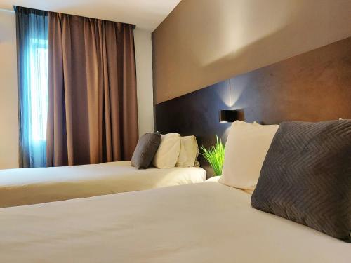 Postel nebo postele na pokoji v ubytování The Leverage Lite Hotel - Kuala Kedah