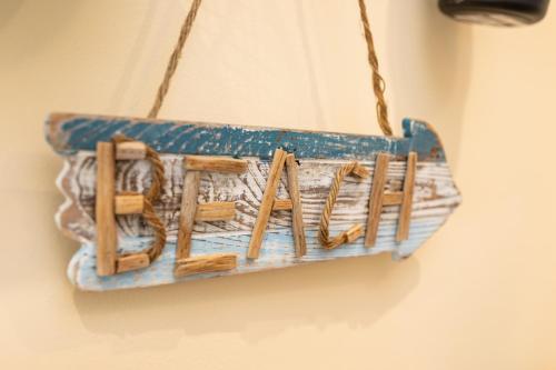 a sign that says home hanging on a wall at Apartman 114 in Baška
