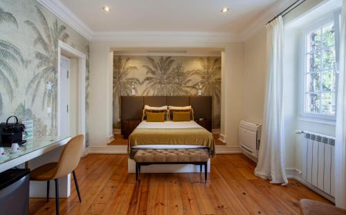a bedroom with a bed and a large window at Casa Vela Boutique House in Cascais