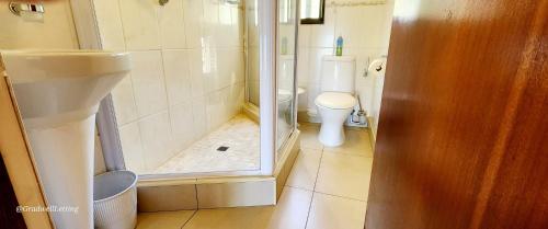 a bathroom with a toilet and a sink and a shower at Seanique - sleeps 8 in Margate