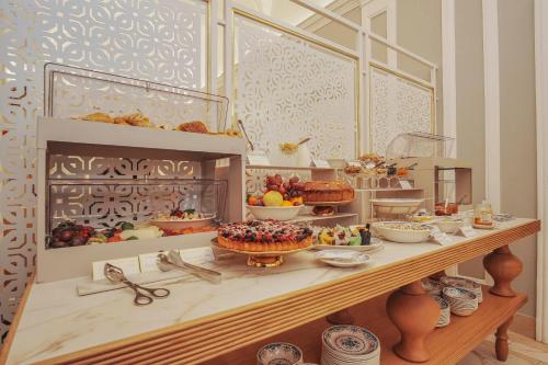 a display case with a bunch of food on a table at Hotel City Palazzo Dei Cardinali in Rome