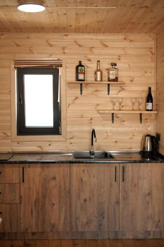 a kitchen with a sink and a window at Sunset Cottage Kazbegi in Kazbegi