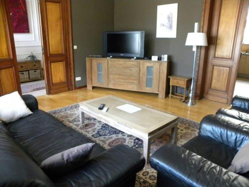 a living room with a couch and a coffee table at Lovely Bourg house 4 pers 2 bedr 2 bath Wifi in Charleroi