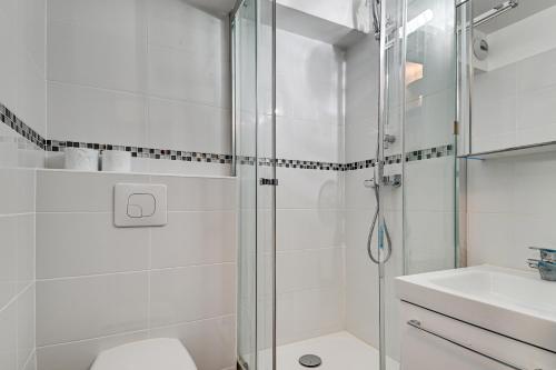 a bathroom with a shower and a toilet and a sink at Budget Studio with parking in Cergy